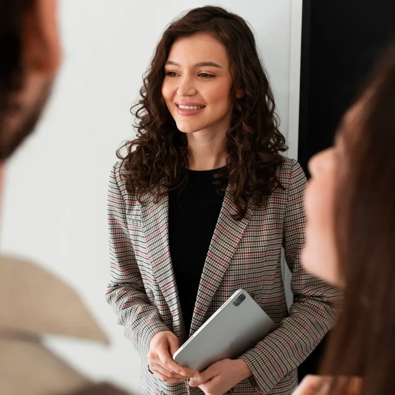 professional Woman smiling holding a tab at Halsen Solutions